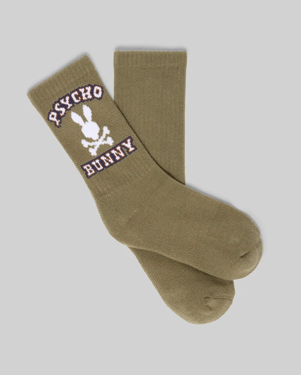 The Psycho Bunny KIDS 3 PACK SPORT SOCKS (KO2200005) includes durable cotton socks in olive green with a white skull and bunny logo plus "PSYCHO BUNNY" in white and purple, displayed on a plain gray background.