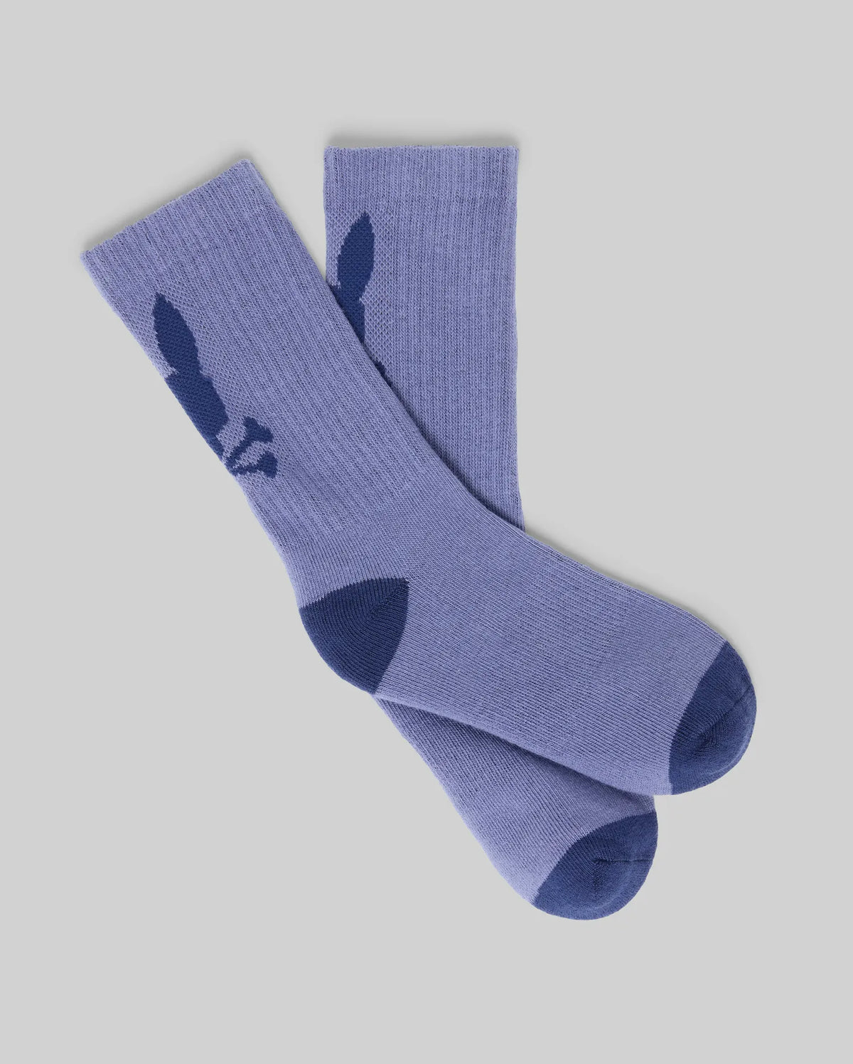 The Psycho Bunny KIDS 3 PACK SPORT SOCKS (KO2200005) includes purple cotton sport socks with dark blue toe and heel, plus a dark blue bunny silhouette near the top. These durable socks are displayed flat on a light gray background.