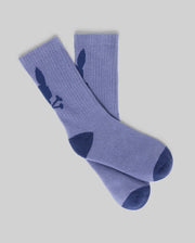 The Psycho Bunny KIDS 3 PACK SPORT SOCKS (KO2200005) includes purple cotton sport socks with dark blue toe and heel, plus a dark blue bunny silhouette near the top. These durable socks are displayed flat on a light gray background.