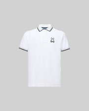 The Psycho Bunny KIDS JUDE PIQUE POLO (KT0100027) is a white Pima cotton short-sleeve polo with black trim on the collar and sleeve cuffs and an embroidered bunny logo on the left chest, shown against a plain gray background.