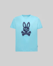 The KIDS DEREK CENTER GRAPHIC TEE (KT0200006) by Psycho Bunny features a large navy bunny with crossed bones and "Psycho Bunny" text on soft Pima cotton in light blue, shown against a plain gray background.