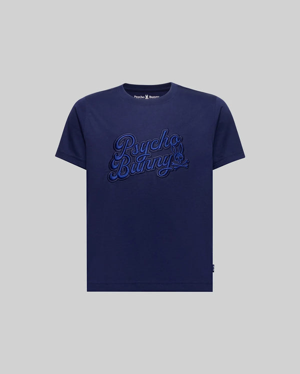 The KIDS ELIAS GRAPHIC TEE (KT0200013) by Psycho Bunny is a navy blue Pima cotton t-shirt featuring bold "Psycho Bunny" script embroidery on the chest in a retro style, displayed on a plain grey background.