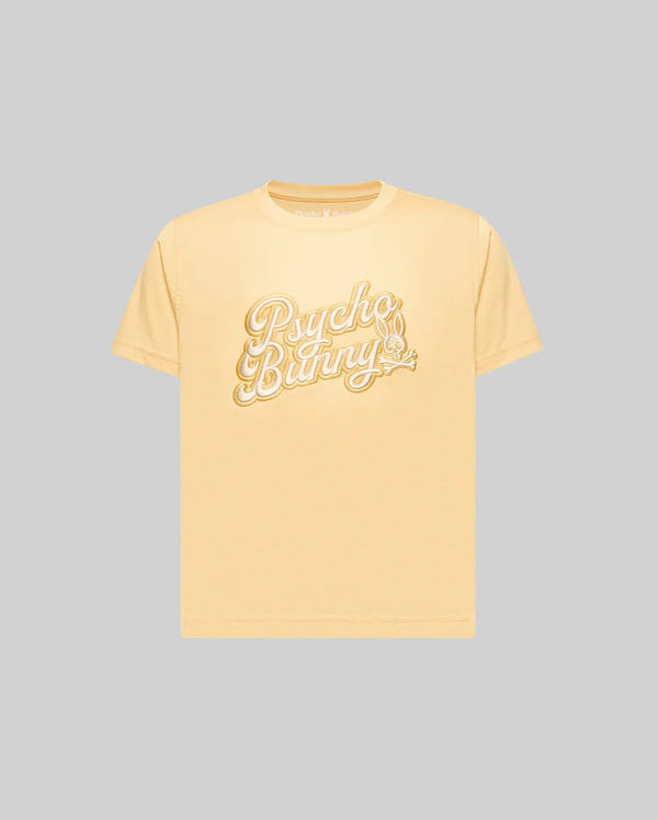 The KIDS ELIAS GRAPHIC TEE (KT0200013) by Psycho Bunny is a light yellow, retro-style short-sleeve Pima cotton t-shirt featuring "Psycho Bunny" in large white script and a bunny with a carrot, shown on a plain gray background.