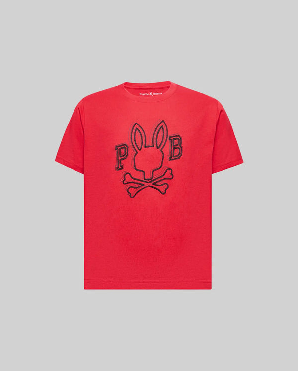 The Psycho Bunny KIDS BALES GRAPHIC TEE (KT0200021) is a red Pima cotton shirt with a bold black outline rabbit-head-and-crossbones graphic, flanked by “P” and “B,” shown on a plain gray background. Perfect for year-round wear.