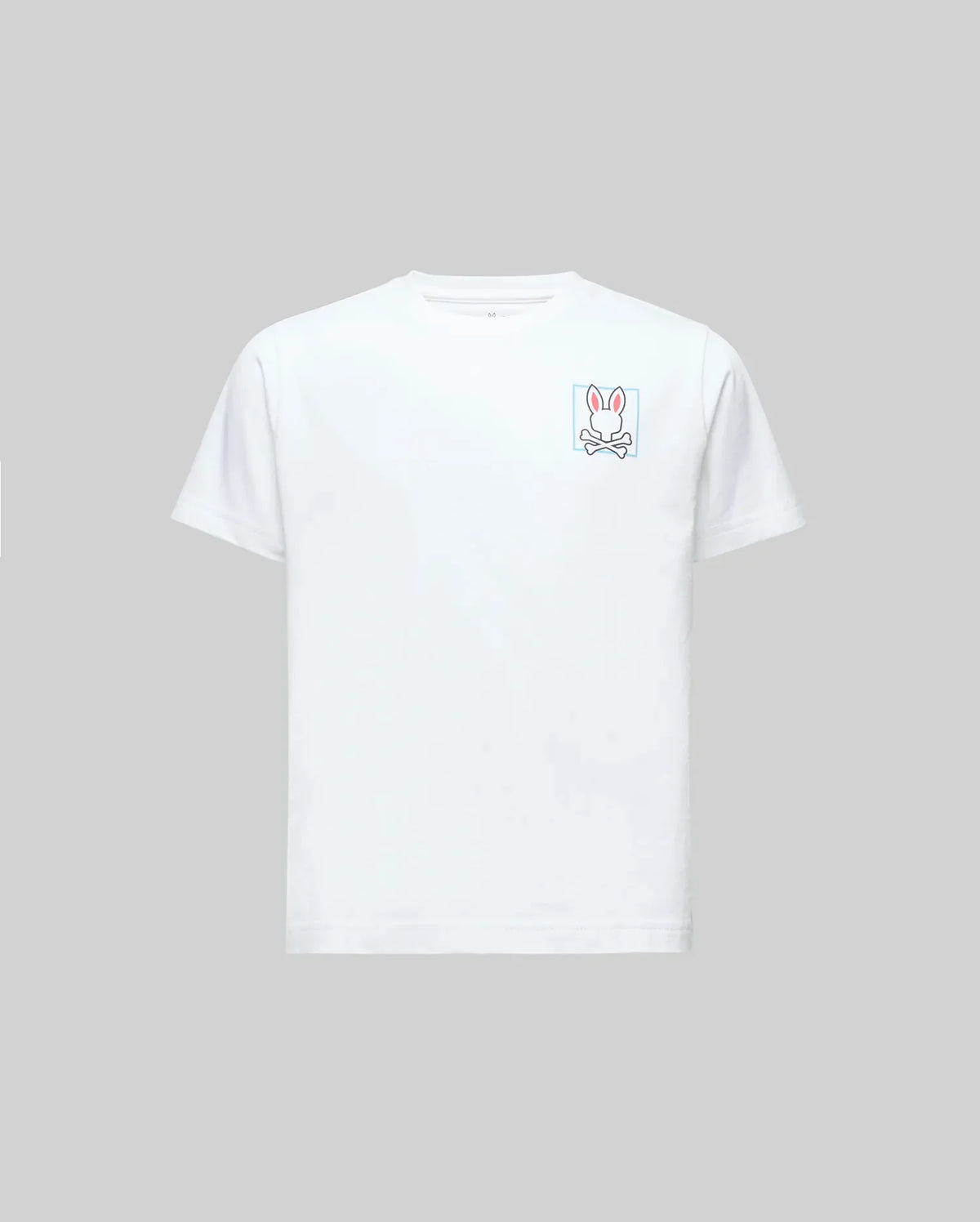 The Psycho Bunny KIDS JESSE GRAPHIC TEE (KT0200031) is a white Pima cotton short-sleeve, featuring a pink-outlined bunny and crossbones graphic on the left chest with eco-friendly water-based prints, shown on a gray background.