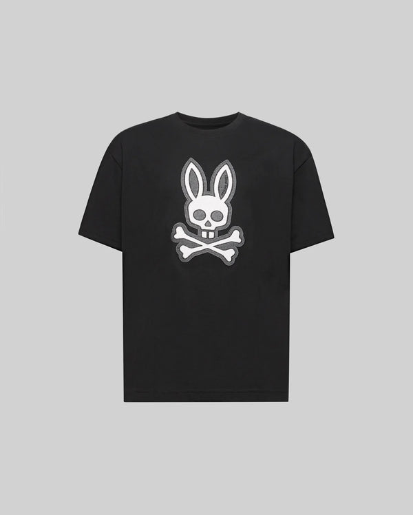 The Psycho Bunny KIDS RYDER OVERSIZED FIT TEE (KT0200056) is a black premium tee crafted from soft Pima cotton, featuring a white embroidered Bunny skull with bunny ears above crossed bones against a gray background.