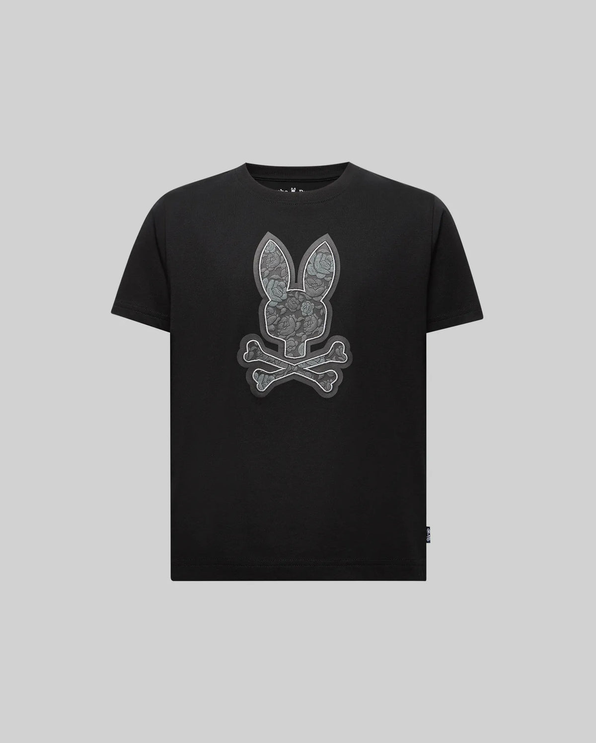 The Psycho Bunny KIDS ROWEN BUNNY GRAPHIC TEE (KT0200058) features a bold bunny head above crossed bones on light gray Pima cotton, crafted in Peru.