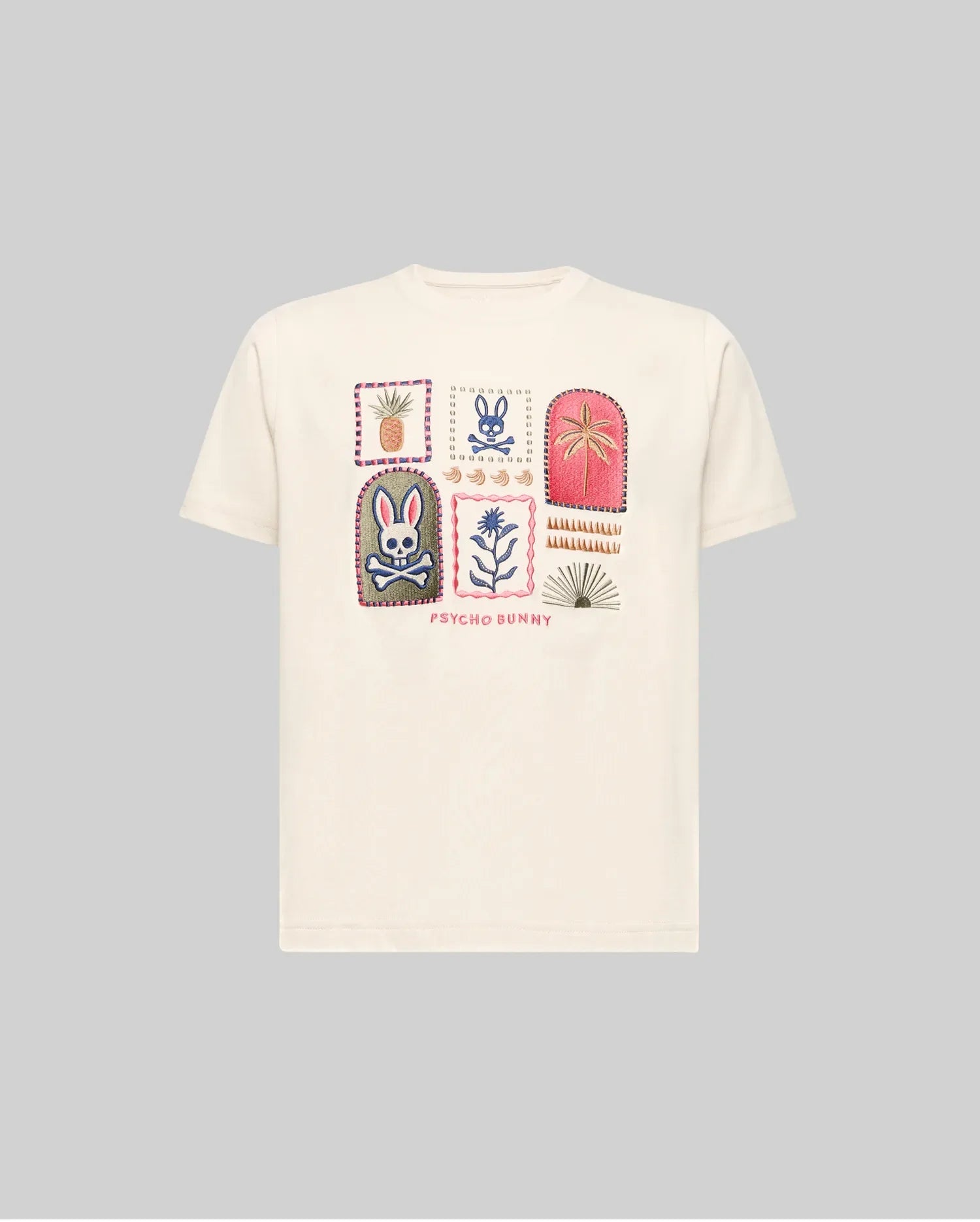 The Psycho Bunny KIDS SUNDEW GRAPHIC TEE (KT0200092) is a white Pima cotton t-shirt with six colorful patch-style graphics—such as a bunny, flower, plant, and geometric designs—and "Psycho Bunny" in red below the images.