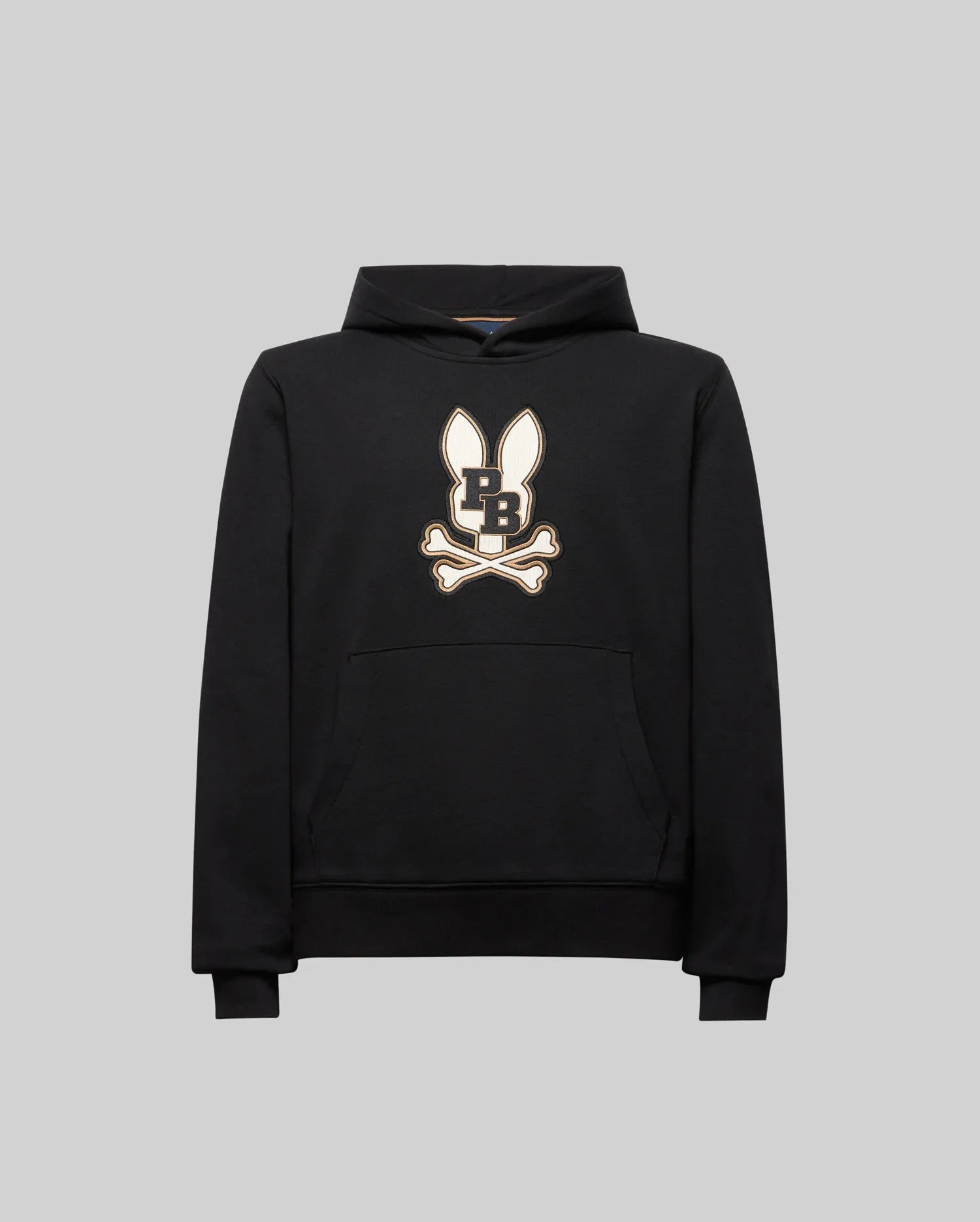 The Psycho Bunny KIDS WADE CORD PATCH HOODIE (KT0500031) is a black athletic hoodie in a premium cotton blend, featuring an embroidered long-eared Bunny patch with "PB" on the chest, shown on a plain gray background.