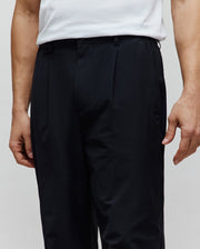 Mens Malik Wide Leg Pant in black, featuring a relaxed wide leg fit, front pleats, and a small tonal embroidered Psycho Bunny skull logo on the right hip.