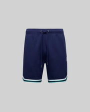 The Psycho Bunny MENS BASIL TAPED SHORT - MB0900005 features navy blue cotton-modal fabric, white and teal stripes near the hem, a drawstring waist, and is shown on a plain grey background.
