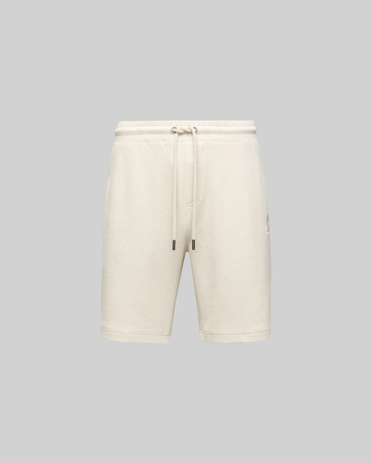 The Psycho Bunny MENS KAI TWILL TEXTURE SWEATSHORT (MB0900015) in beige features a twill-textured finish, elastic waistband with adjustable drawstring, side pockets, and an embroidered Bunny logo, shown against a gray background.