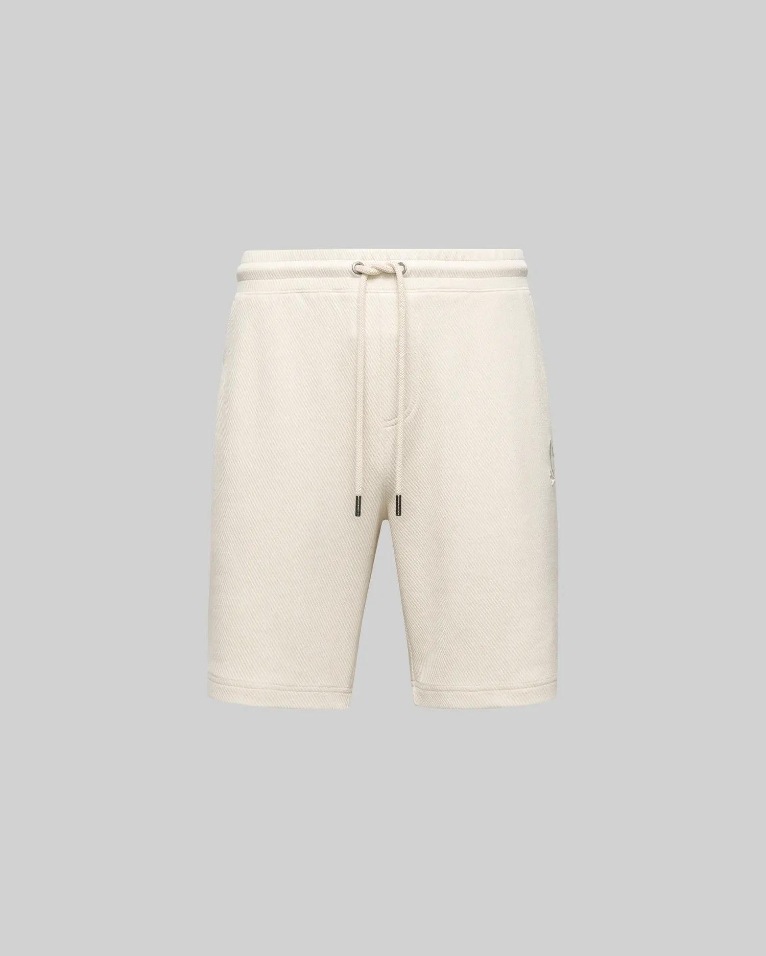 The Psycho Bunny MENS KAI TWILL TEXTURE SWEATSHORT (MB0900015) in beige features a twill-textured finish, elastic waistband with adjustable drawstring, side pockets, and an embroidered Bunny logo, shown against a gray background.