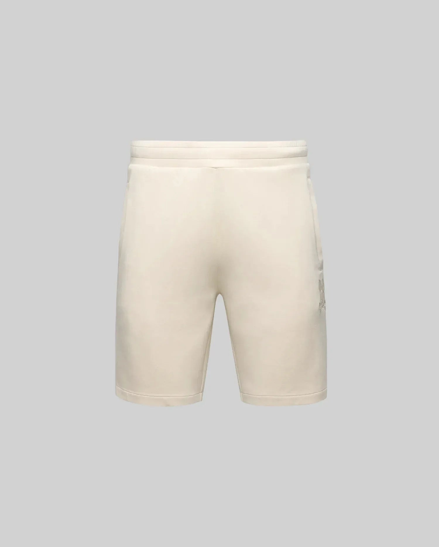 The Psycho Bunny MENS LAZSLO SWEATSHORT (MB0900016) in light beige features an elastic waistband, side pockets, and a stretch modal-cotton-blend for comfort—ideal for casual wear. Shown from the front on a plain gray background.