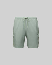The Psycho Bunny MENS RANDY BOARD SWIM SHORT (MB1000002) in light green features an elastic waistband, drawstring, and two side cargo pockets—ideal for a relaxed beach day. Shown on a plain light grey background.