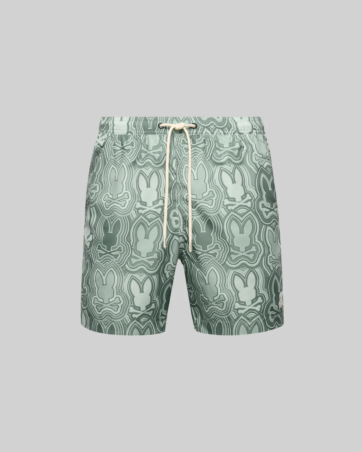 The Psycho Bunny MENS CHUCK ALL OVER PRINT LIGHTWEIGHT SWIM TRUNK (MB1000003) features an abstract green bunny pattern, quick-dry recycled polyester fabric, and a white drawstring waist, shown on a plain gray background.
