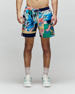 A person faces forward, shown from shoulders to feet against a light background, wearing Psycho Bunny MENS BLAISE SWIM TRUNK - MB1000028 with playful bunny logos, plus sandals and socks.