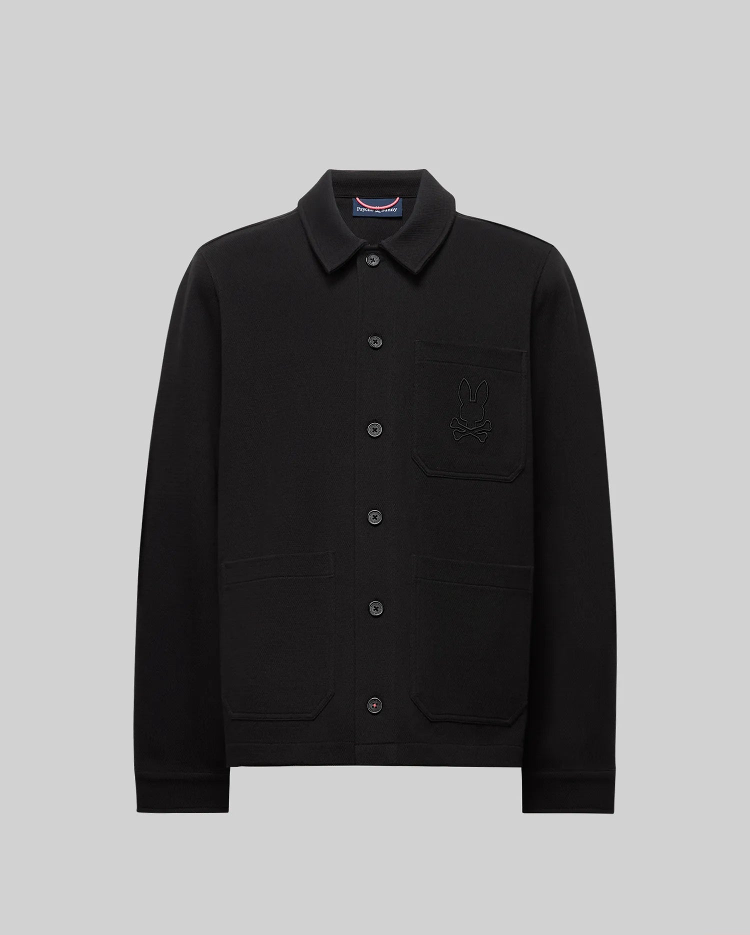 The Psycho Bunny MENS AVEN KNIT SHACKET (MO1100035) is a black knit shacket with a stylish cat design, offering transitional comfort and effortless layering.
