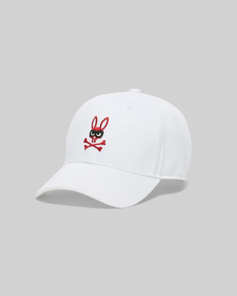 The Psycho Bunny MENS MISCHIEF BASEBALL CAP (MO1500015) is a white 100% cotton cap featuring an embroidered black and red Mischief Bunny logo—a cartoon rabbit head with crossbones—on the front panel, shown against a gray background.