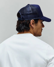 Navy Mens Toby Trucker Cap, a Psycho Bunny essential, featuring a structured front panel and breathable mesh back, paired with a soft white classic fit jersey crew neck t-shirt.
