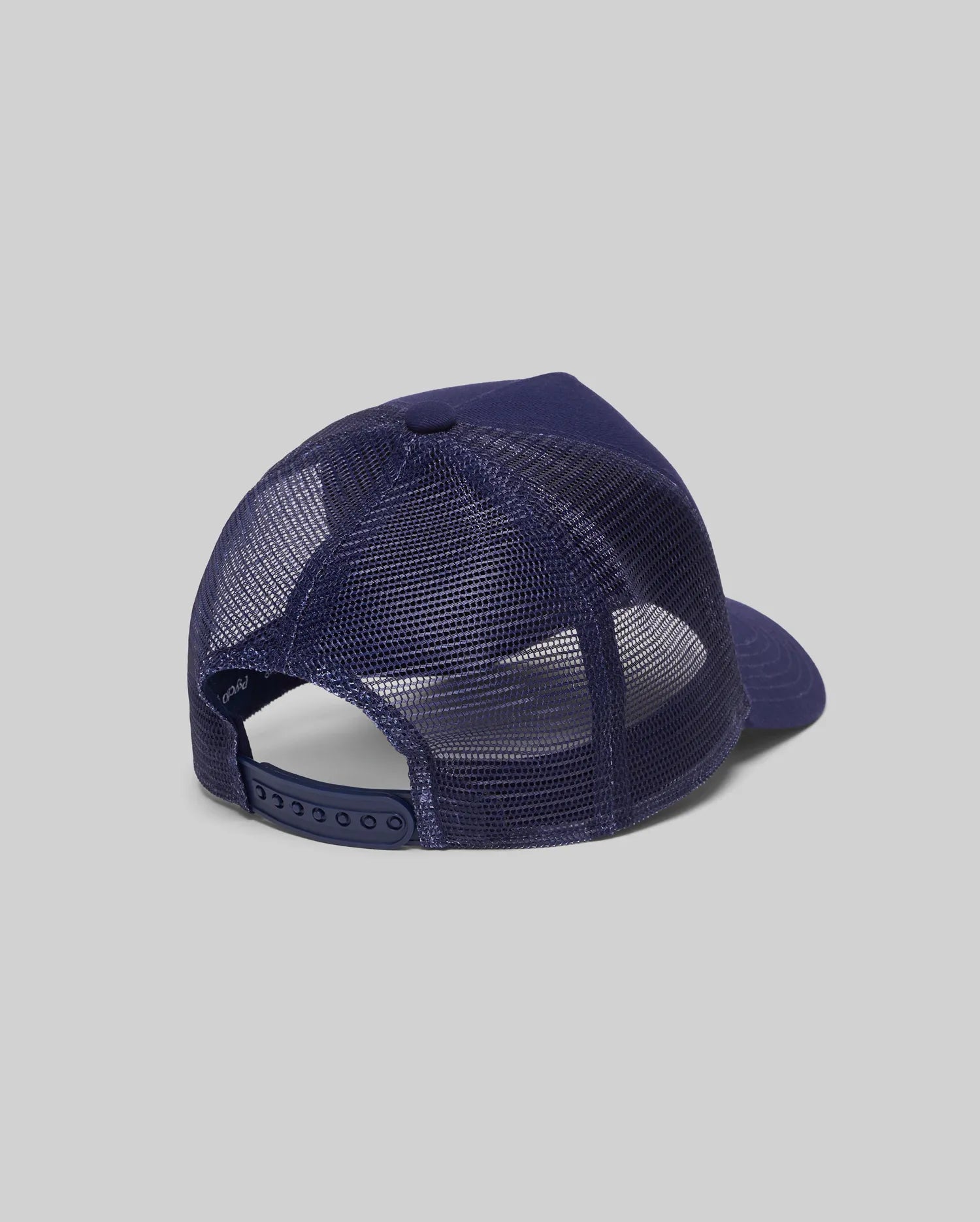 Mens Toby Trucker Cap in navy blue, featuring a classic trucker fit with solid front panels, breathable mesh back, and an adjustable snapback closure. Inner band shows Psycho Bunny text.