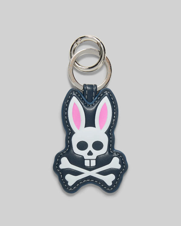 Make a statement with the Psycho Bunny MENS PUFFER BUNNY KEYCHAIN—MO1700008, featuring a navy bunny with white skull and crossbones, pink inner ears, and silver key rings from the iconic brand.