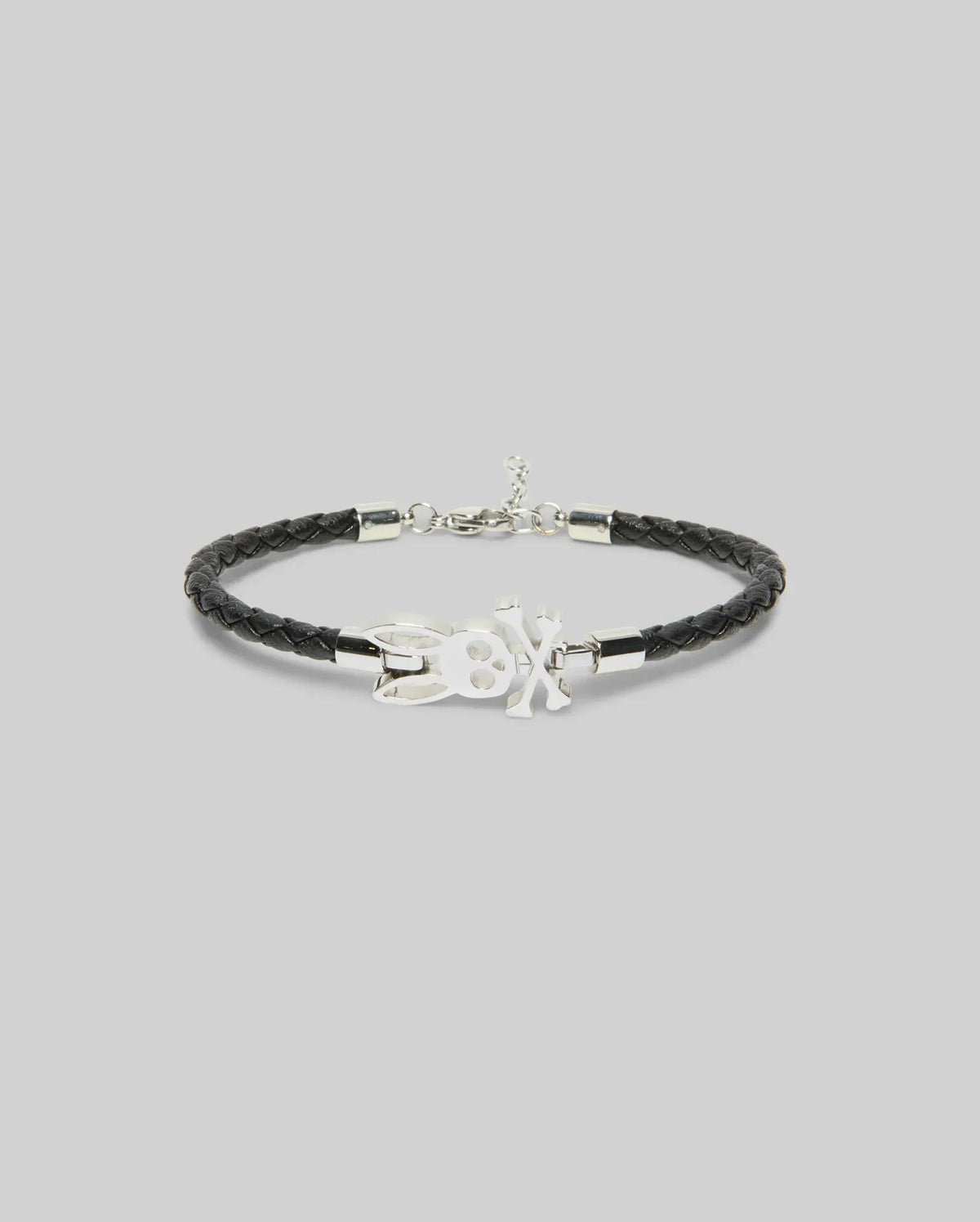 The Psycho Bunny MENS LEATHER BUNNY BRACELET - MO1700024 features black braided leather, a silver clasp, and a central silver bunny charm, shown on a plain light gray background—perfect for everyday wear.
