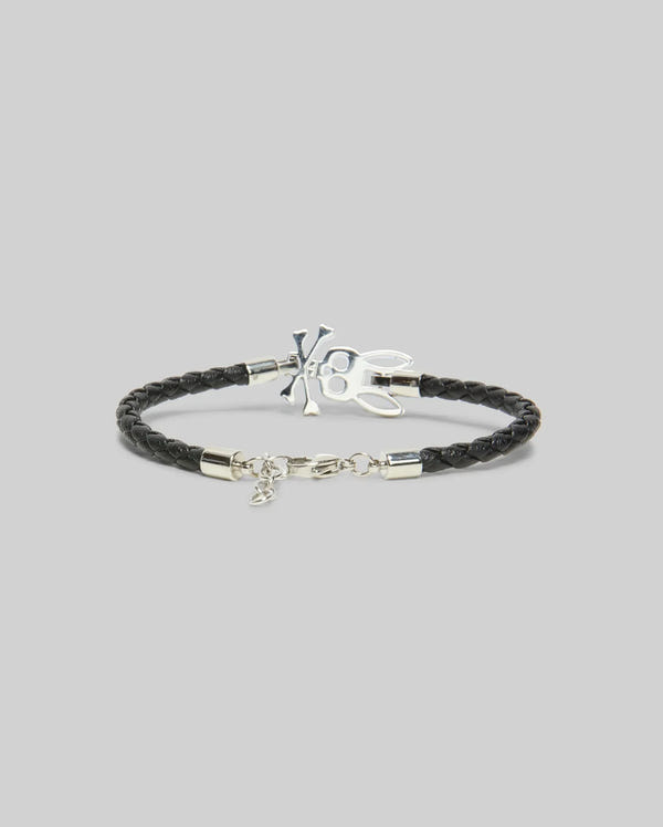 The Psycho Bunny MENS LEATHER BUNNY BRACELET - MO1700024 features black braided PVC leather, a silver-tone clasp, and a signature bunny charm—an edgy accessory ideal for everyday wear, shown on a plain gray background.