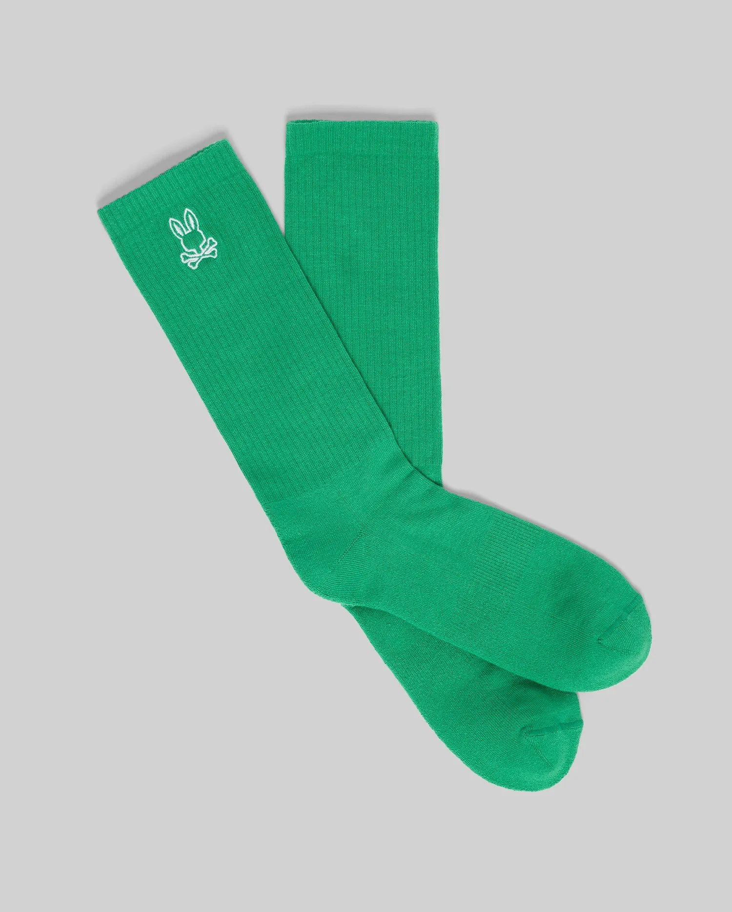 The Psycho Bunny MENS NEW CLASSIC SPORT SOCK - MO2200001 is a bright green pair featuring a white embroidered bunny logo near the top, shown on a light gray background.