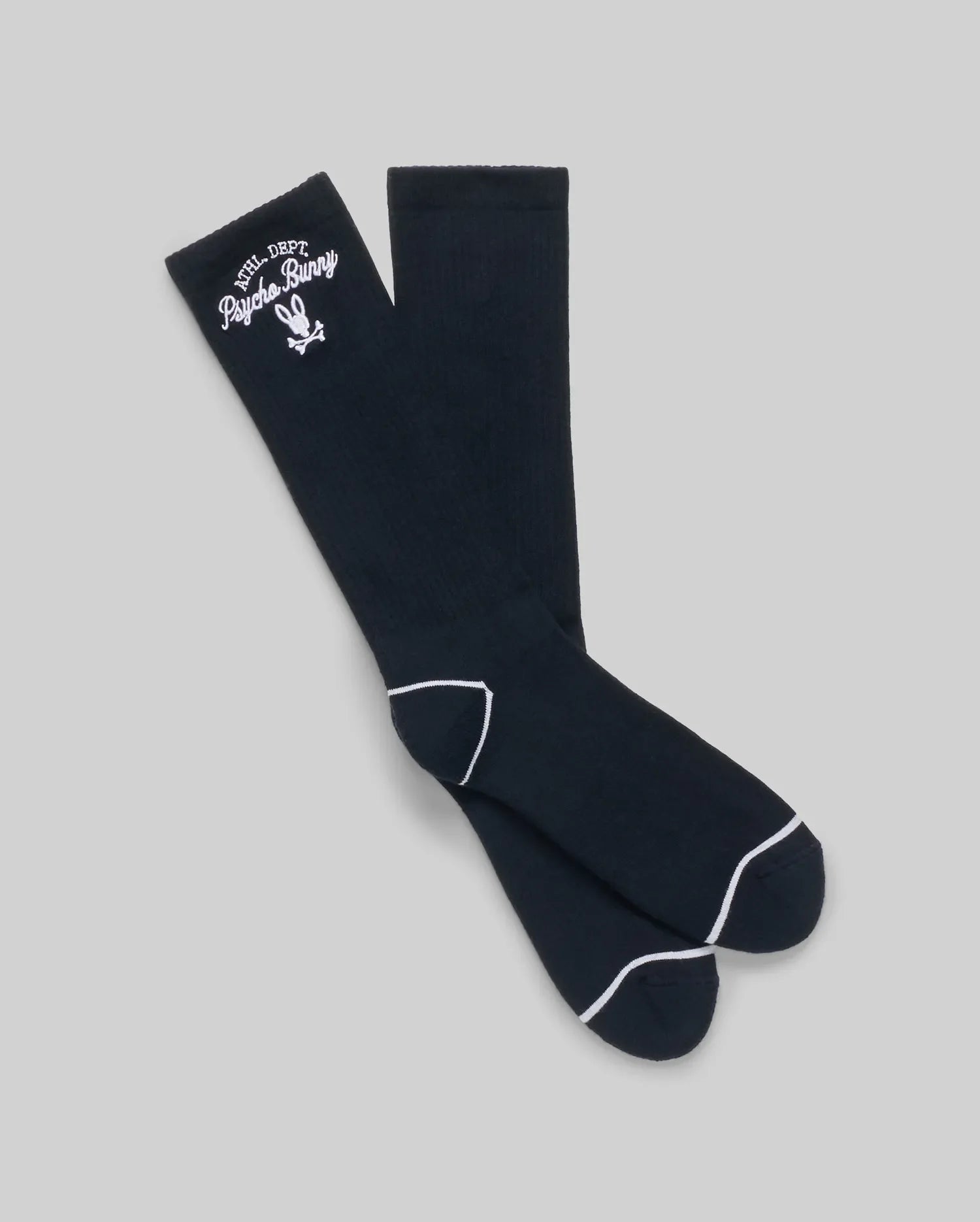 The Psycho Bunny MENS 3 PACK SPORT SOCK (MO2200006) features black knee-high socks with white trim, embroidered text, and a bunny logo near the top. Made from soft Pima cotton, they're displayed on a plain light gray background.
