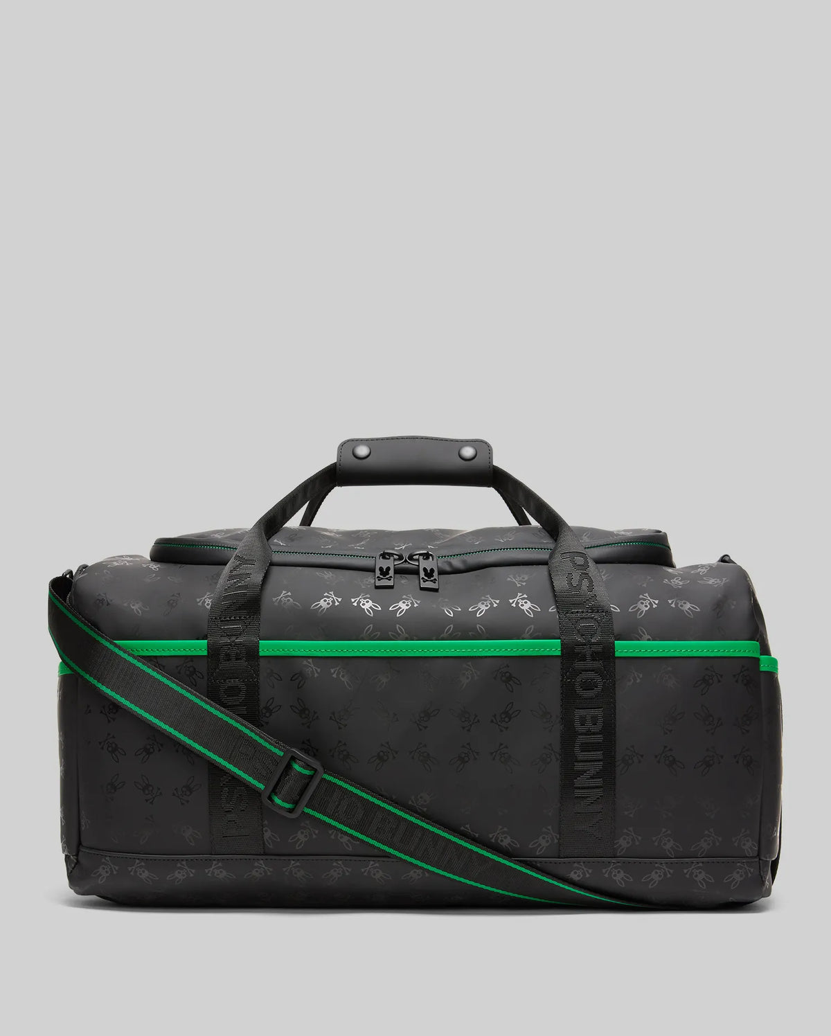 Black Gym Bag with an all-over tonal embossed Psycho Bunny skull logo pattern, vibrant green piping, and a shoulder strap featuring PSYCHO BUNNY branding.