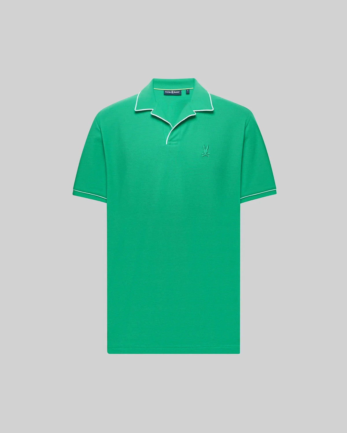The Psycho Bunny MENS JAXON SOFT PIQUE CAMP COLLAR POLO (MT0100006) is a green short-sleeve Pima cotton polo with white piping on the collar and sleeves, an embroidered Bunny logo on the chest, shown against a light gray background.