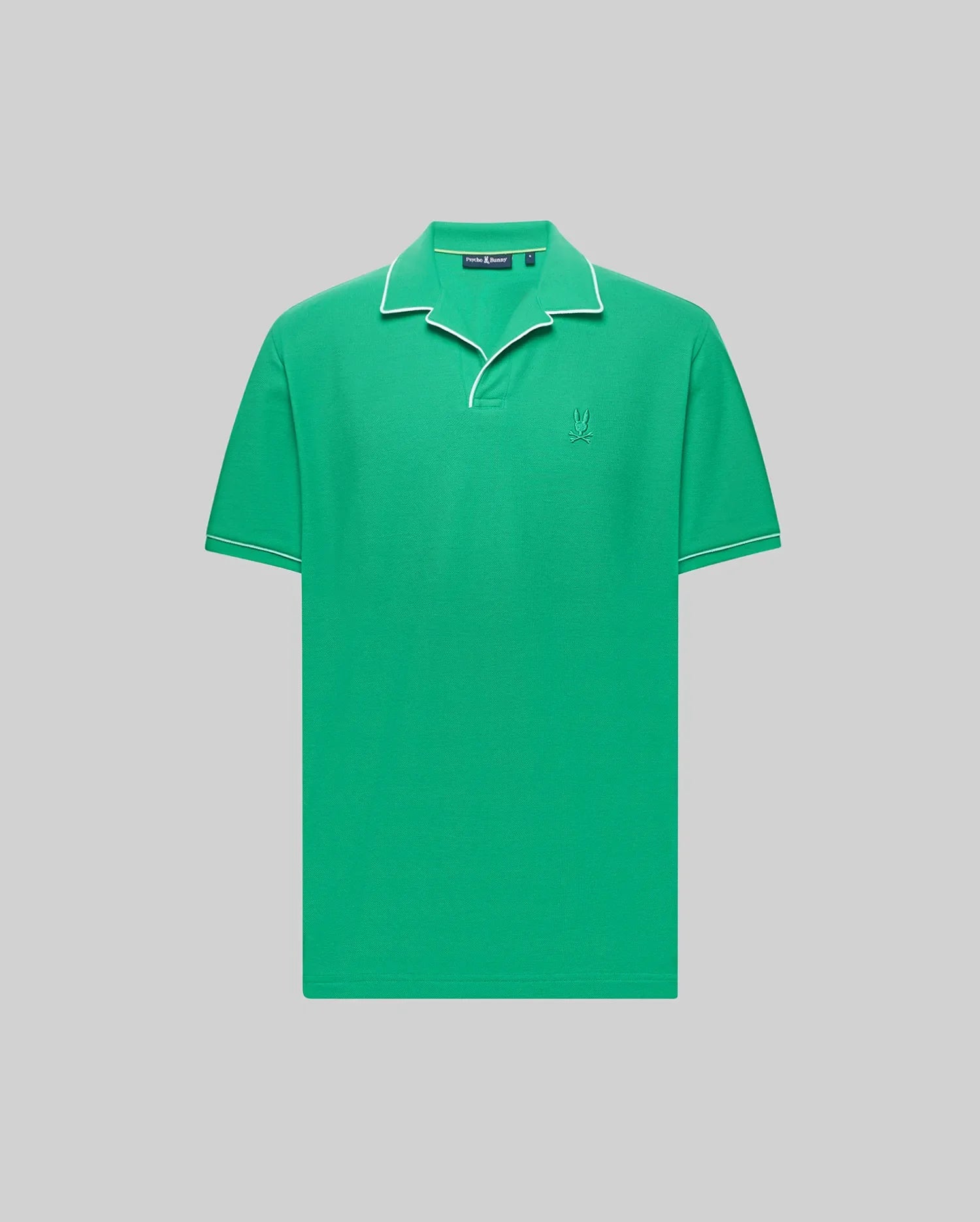 The Psycho Bunny MENS JAXON SOFT PIQUE CAMP COLLAR POLO (MT0100006) is a green short-sleeve Pima cotton polo with white piping on the collar and sleeves, an embroidered Bunny logo on the chest, shown against a light gray background.
