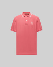 The Psycho Bunny MENS FENLEY PIQUE POLO (MT0100009) offers ultra-soft Pima cotton in pink with a white-trimmed collar and an embroidered Bunny logo on the chest, shown against a plain gray background.