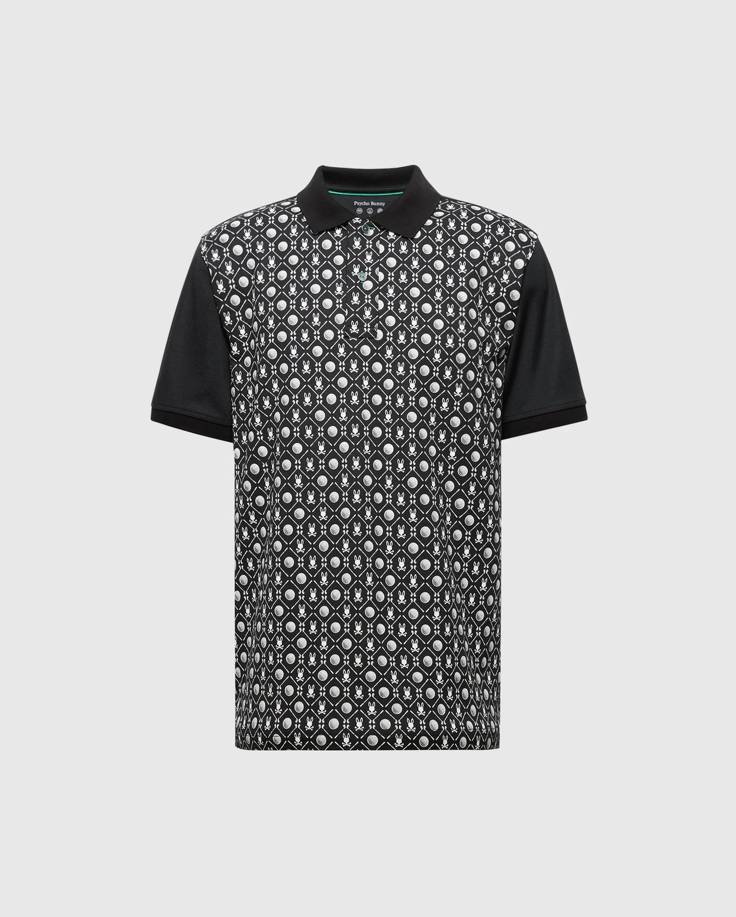 The Psycho Bunny MENS BECKETT PIQUE POLO (MT0100022) is a black short-sleeve Pima cotton shirt with solid black collar and sleeves, featuring a white and gray geometric front pattern on black, shown on a light gray background.