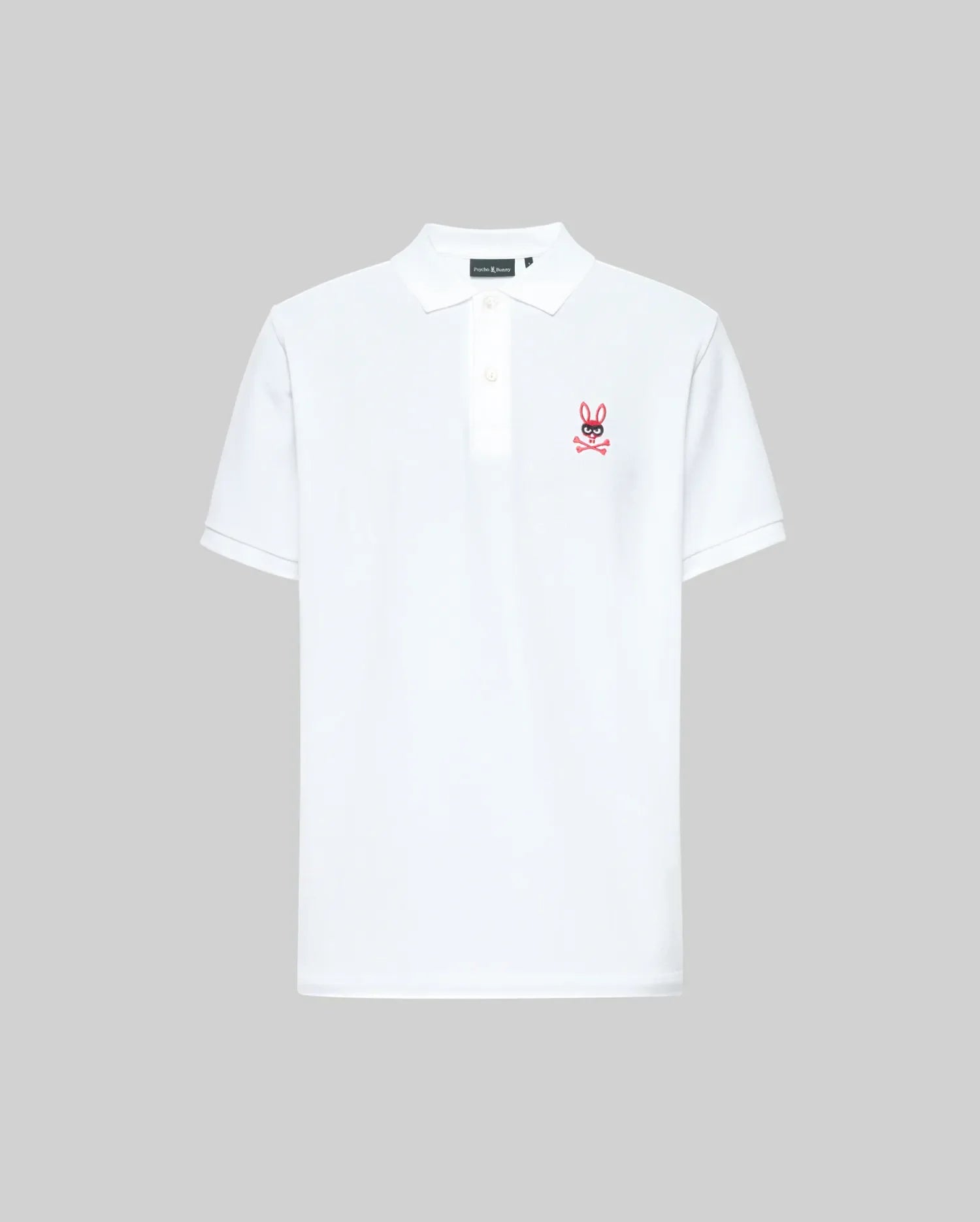 The Psycho Bunny MENS MISCHIEF BUNNY PIQUE POLO (MT0100025) is a white Pima cotton short-sleeve shirt with a collar, two mother-of-pearl buttons, and a small red and pink bunny logo on the left chest, shown on a light gray background.