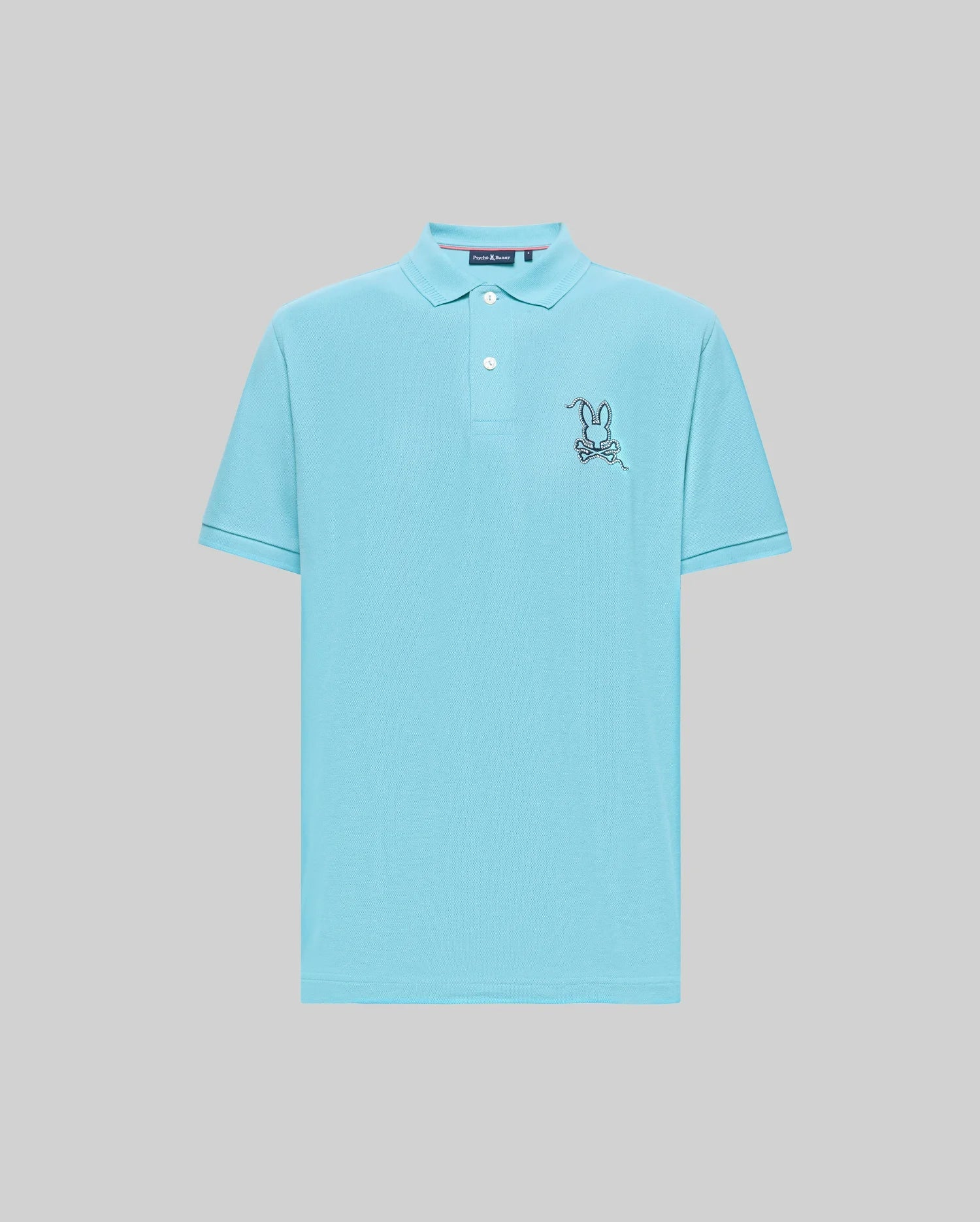 The Psycho Bunny MENS CYRUS PIQUE POLO - MT0100056 features light blue Pima cotton, short sleeves, a collar with two buttons, and an embroidered cartoon rabbit holding a bone on the left chest.