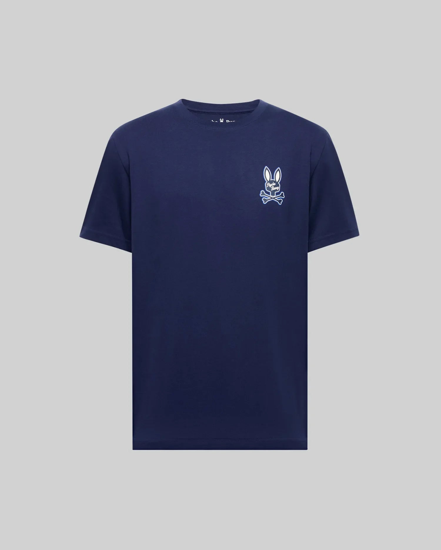 The Psycho Bunny MENS DEREK CHEST GRAPHIC TEE (MT0200009) is a navy Pima cotton crewneck with a small white bunny face and bow tie graphic on the left chest, shown against a light gray background.