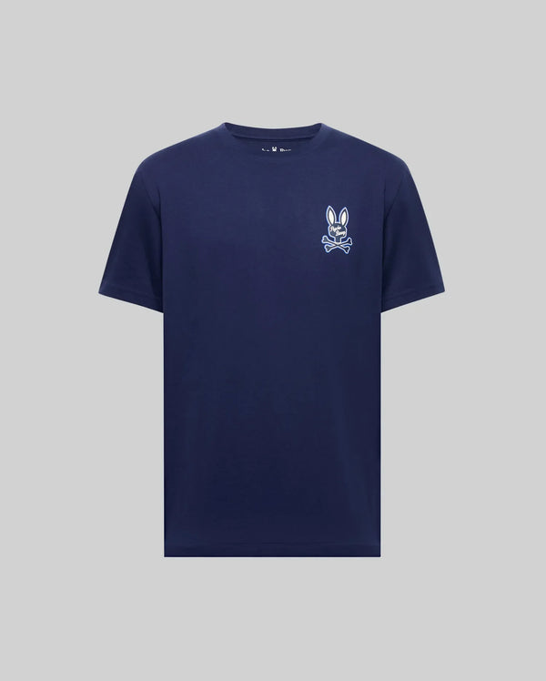 The Psycho Bunny MENS DEREK CHEST GRAPHIC TEE (MT0200009) is a navy Pima cotton crewneck with a small white bunny face and bow tie graphic on the left chest, shown against a light gray background.