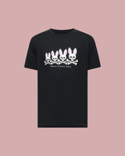 The Psycho Bunny MENS ARCHIVE GRADIANT BUNNY GRAPHIC TEE (MT0200029) showcases four iconic white and pink Bunny skull and crossbones with "BOLD SINCE 2005" text, set against a plain light pink background.