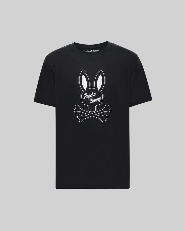 The Psycho Bunny MENS DEREK CENTER GRAPHIC TEE (MT0200048) is a black Pima cotton t-shirt with a white outlined bunny head above crossed bones and cursive "Psycho Bunny." Shown on gray. Available in Big and Tall sizes.