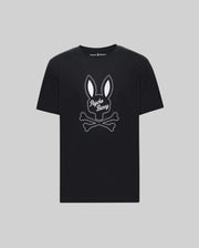 The Psycho Bunny MENS DEREK CENTER GRAPHIC TEE (MT0200048) is a black Pima cotton t-shirt with a white outlined bunny head above crossed bones and cursive "Psycho Bunny." Shown on gray. Available in Big and Tall sizes.