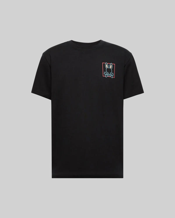 The Psycho Bunny MENS JESSE GRAPHIC TEE (MT0200056) is a plain black Pima cotton shirt with a small, colorful bunny face inside a red rectangle on the left chest, displayed on gray, and printed using eco-friendly water-based inks.