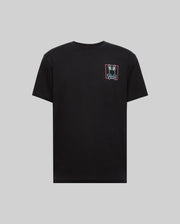 The Psycho Bunny MENS JESSE GRAPHIC TEE (MT0200056) is a plain black Pima cotton shirt with a small, colorful bunny face inside a red rectangle on the left chest, displayed on gray, and printed using eco-friendly water-based inks.