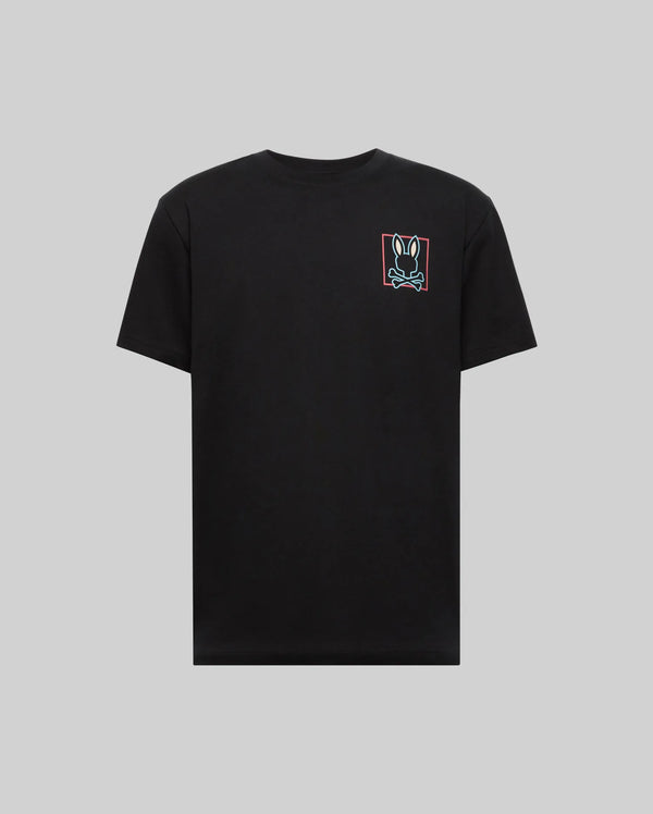 The Psycho Bunny MENS JESSE GRAPHIC TEE (MT0200056) is a plain black Pima cotton shirt with a small, colorful bunny face inside a red rectangle on the left chest, displayed on gray, and printed using eco-friendly water-based inks.