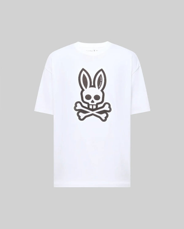 The Psycho Bunny MENS RYDER OVERSIZED FIT TEE (MT0200062) is a premium white Pima cotton T-shirt with an oversized fit, featuring a large black bunny skull and crossbones graphic on the front.