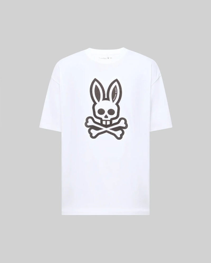 The Psycho Bunny MENS RYDER OVERSIZED FIT TEE (MT0200062) is a premium white Pima cotton T-shirt with an oversized fit, featuring a large black bunny skull and crossbones graphic on the front.