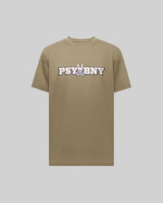 The Psycho Bunny MENS WADE GRAPHIC TEE - MT0200105 is a khaki 100% cotton shirt showcasing "PSYBNY" text and a cartoon bunny skull and crossbones graphic at the center, set against a plain light gray background.