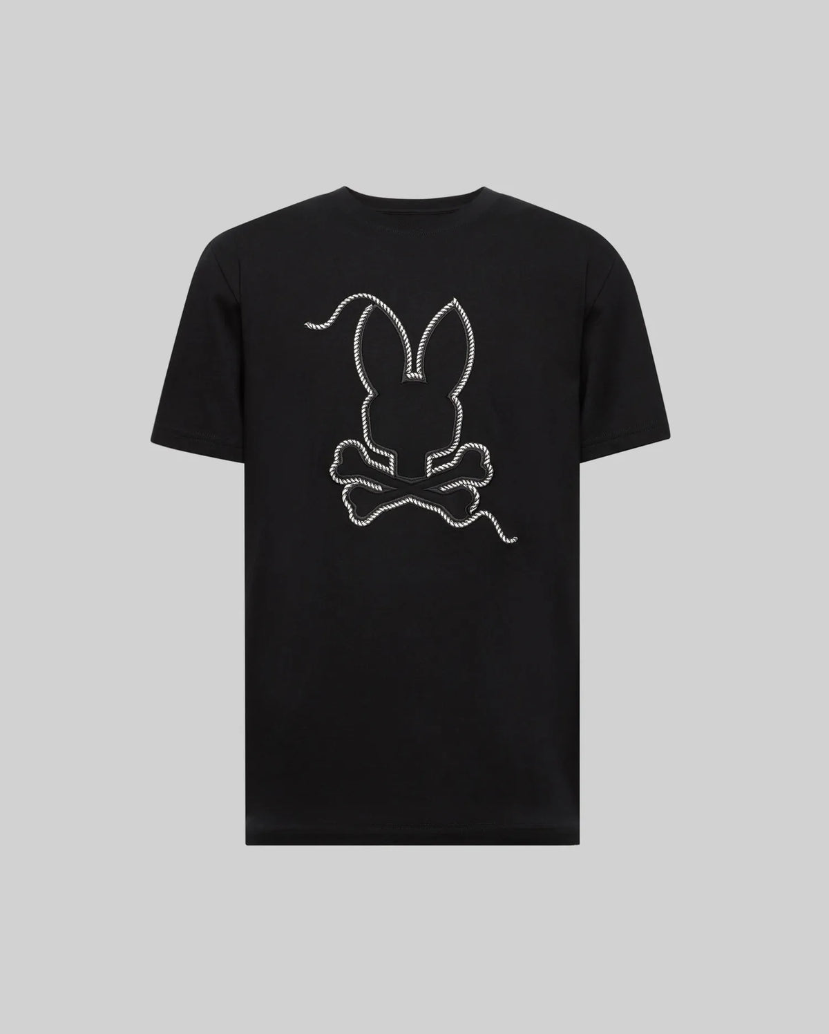 The MENS CYRUS GRAPHIC TEE - MT0200115 by Psycho Bunny is made from 100% Pima cotton, featuring a large outlined bunny head above crossed bones in a rope design on the back, echoing a sailor’s vibe, shown on a plain gray background.