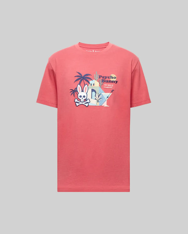 The Psycho Bunny MENS SHANE GRAPHIC TEE - MT0200175 is a pink short-sleeve summer tee with a bunny skull logo, palm trees, Martini glasses, and "Psycho Bunny" text graphic on the chest over a light gray background.